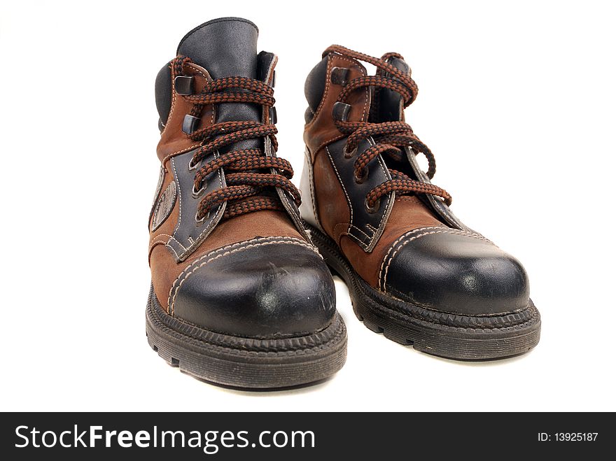 A pair of hiking boots isolated on white background. Shallow depth of field