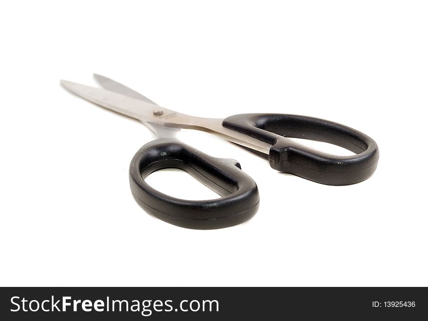 Close up and isolated shot of modern sharp scissors against white