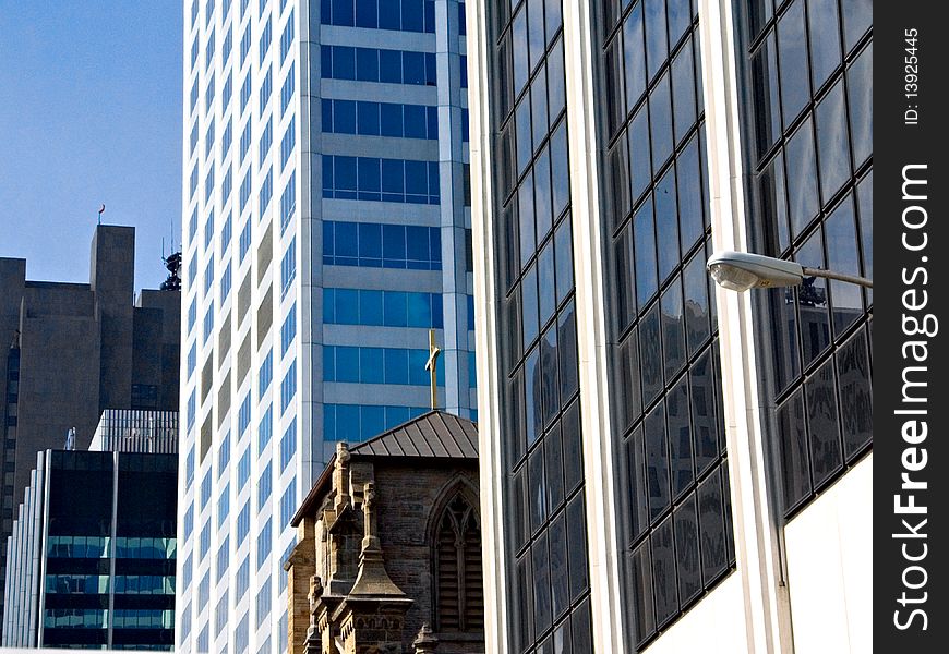 A view of a city with old and new buildings, glass and cement. A view of a city with old and new buildings, glass and cement.