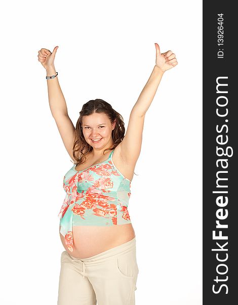 Pregnant woman wearing in beige pants and a colored T-shirt holding hands up