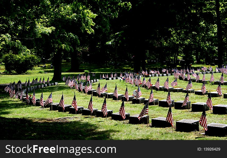 Many flags on the headstones of fallen veterens. Many flags on the headstones of fallen veterens