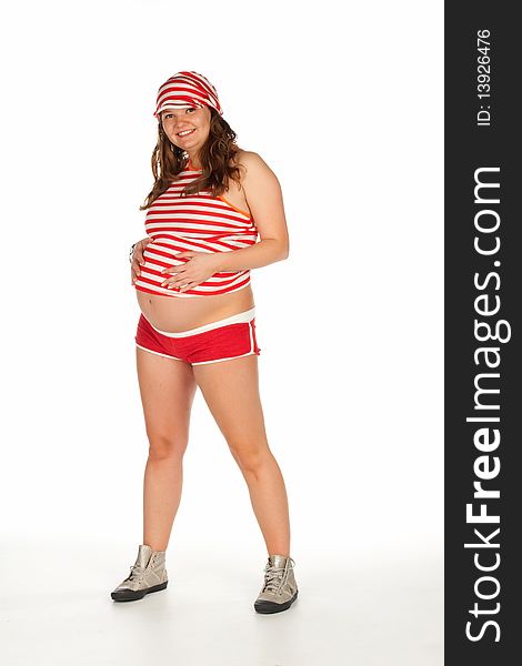 Pregnant beautiful smiling woman in a striped shirt and cap in red and white stripes holding hands on her belly. Pregnant beautiful smiling woman in a striped shirt and cap in red and white stripes holding hands on her belly.