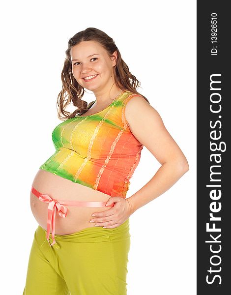 Pregnant beautiful smiling woman in a in green trousers and a colored shirt with a pink ribbon on the belly. Pregnant beautiful smiling woman in a in green trousers and a colored shirt with a pink ribbon on the belly.