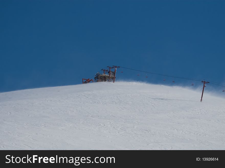 A photo of a ski lift on a cold, windy day near Anchorage, Alaska. It was a bright sunny day with a blue sky background. A photo of a ski lift on a cold, windy day near Anchorage, Alaska. It was a bright sunny day with a blue sky background.