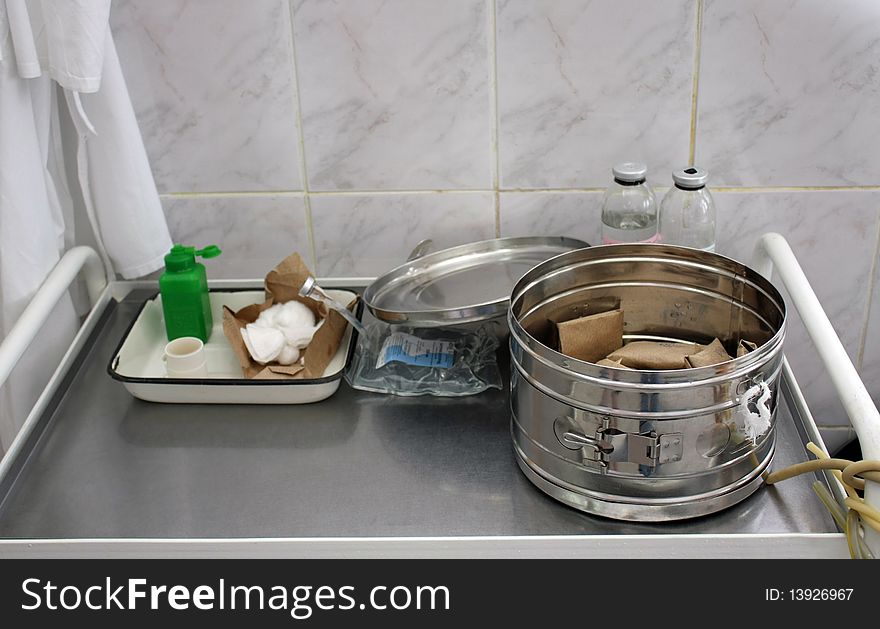 Medical sterilizer and a table with various instruments on it. Medical sterilizer and a table with various instruments on it