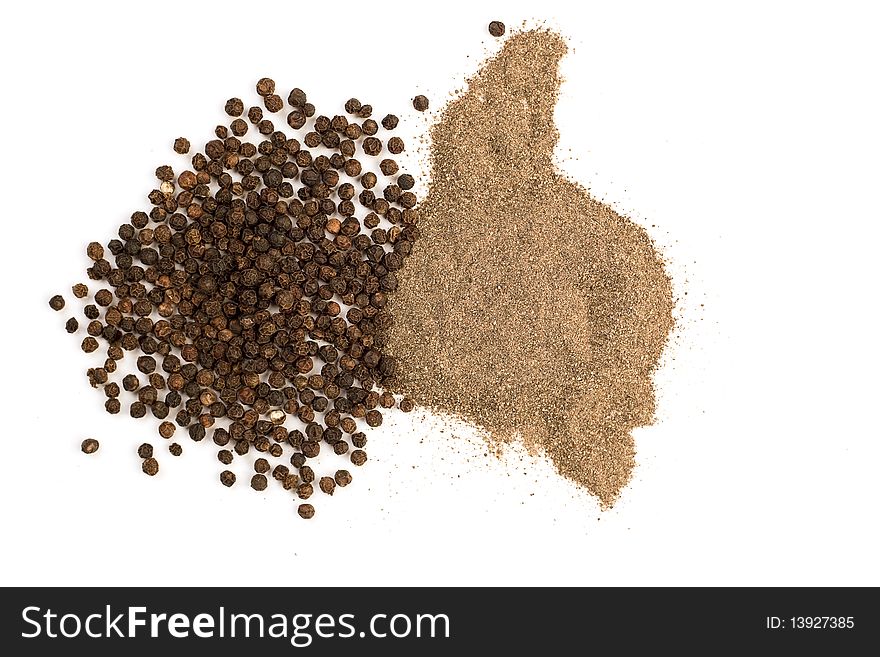 Ground and grains of black pepper