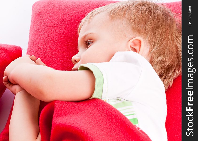 Little boy is sleeping on a red pillow. Little boy is sleeping on a red pillow