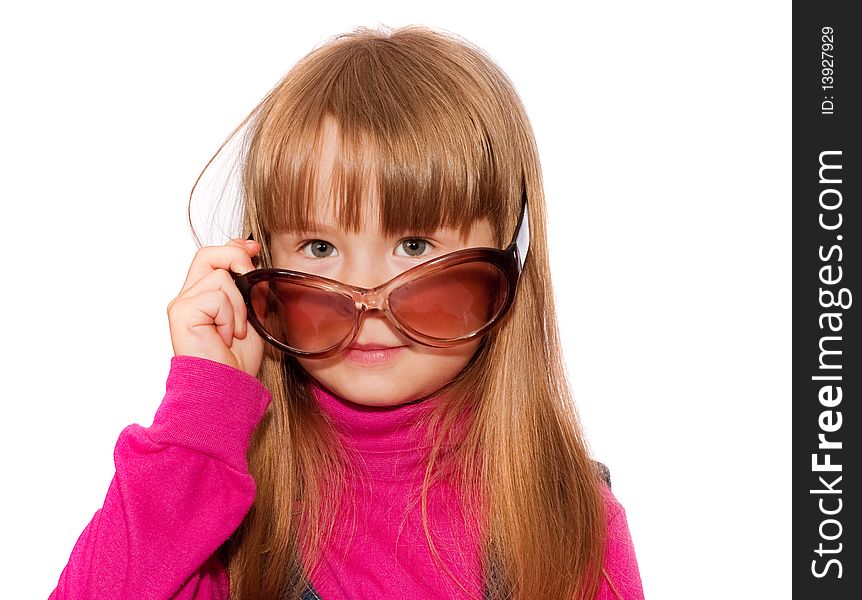 Little girl looks over dark glasses isolated on white