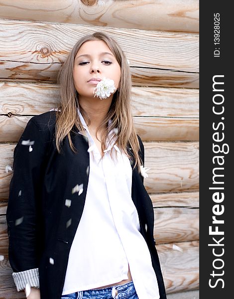 Girl standing in front of a wooden house. Girl standing in front of a wooden house