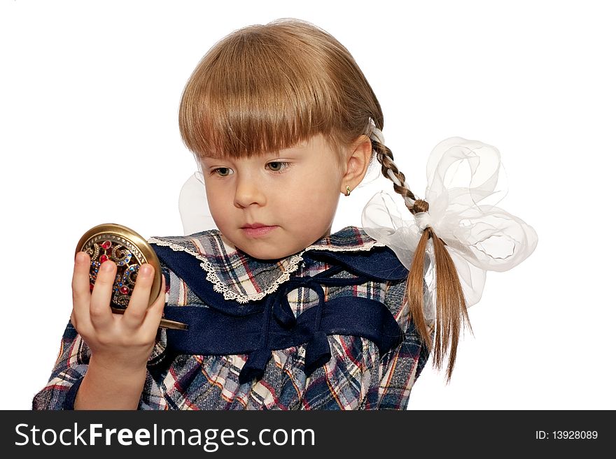 Little girl looks in pocket mirror isolated on white