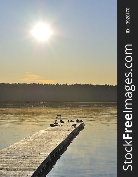 A backlit bridge in a lake. A backlit bridge in a lake.