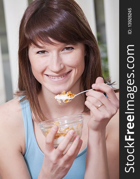 Smiling woman with a bowl corn flakes. Smiling woman with a bowl corn flakes