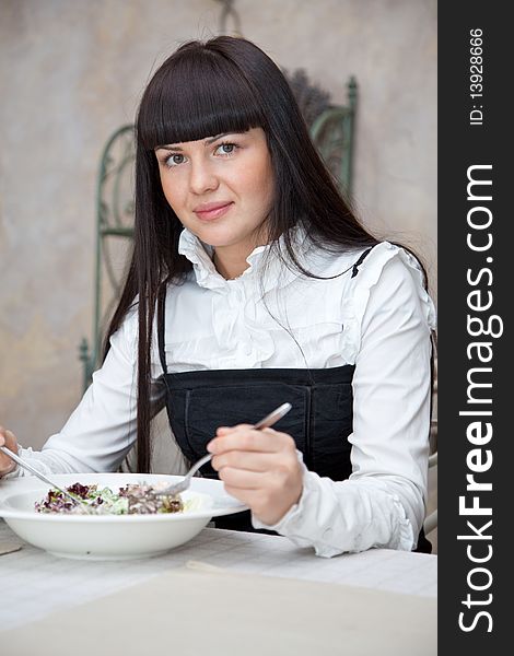 Woman eating in restaurant