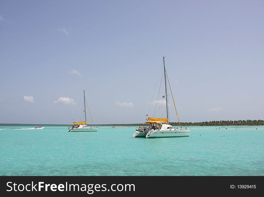 Catamarana and people swiming in caribbean sea