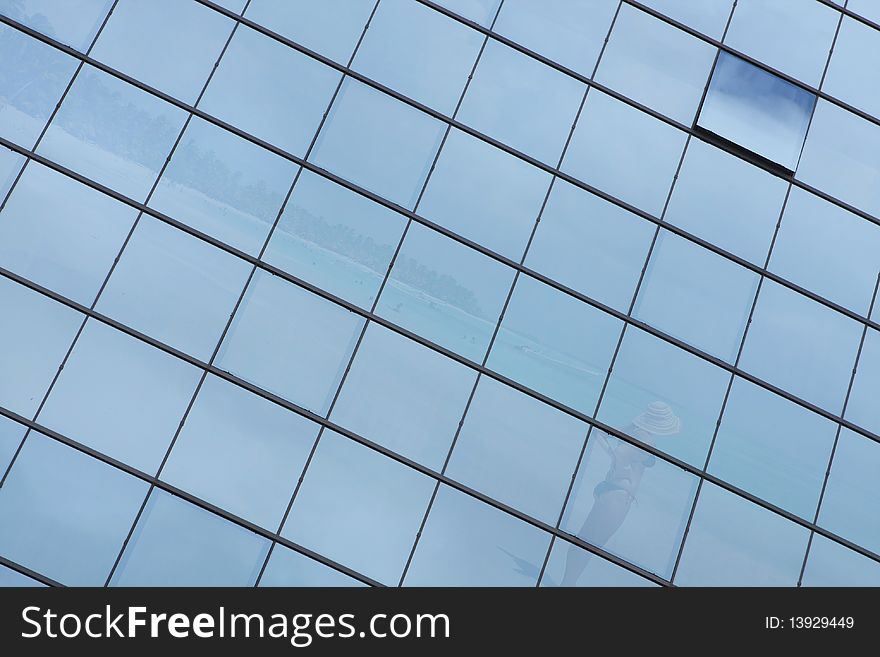 Glass pattern of a building with a beach refleted