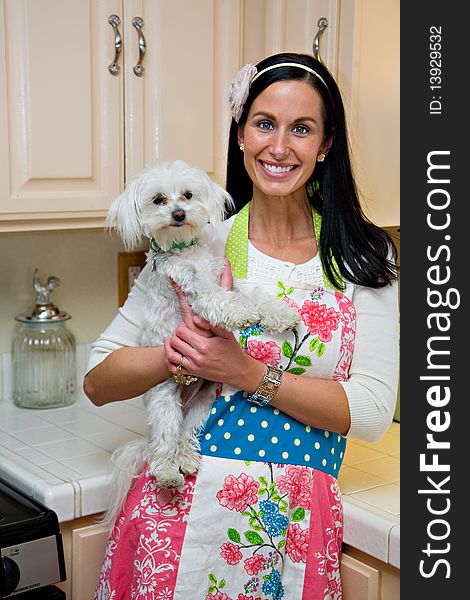 Smiling Woman With Cute Dog In Kitchen