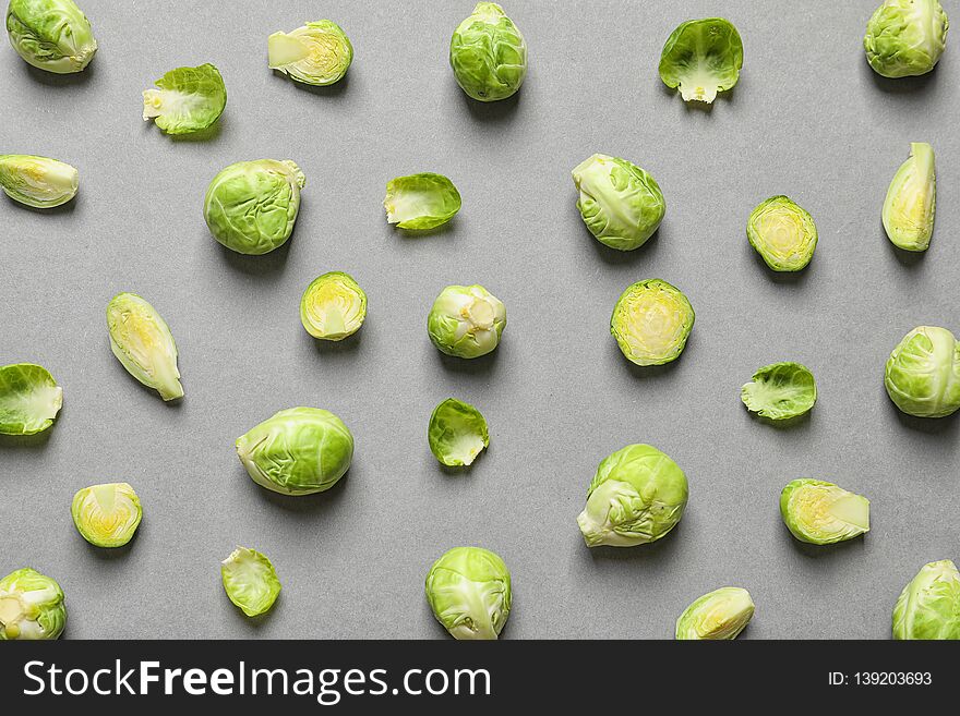 Tasty fresh Brussels sprouts on grey background, top view
