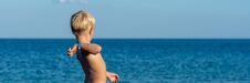Free Blonde Toddler Boy Throwing Stone Into A Sea Royalty Free Stock Images - 139222629