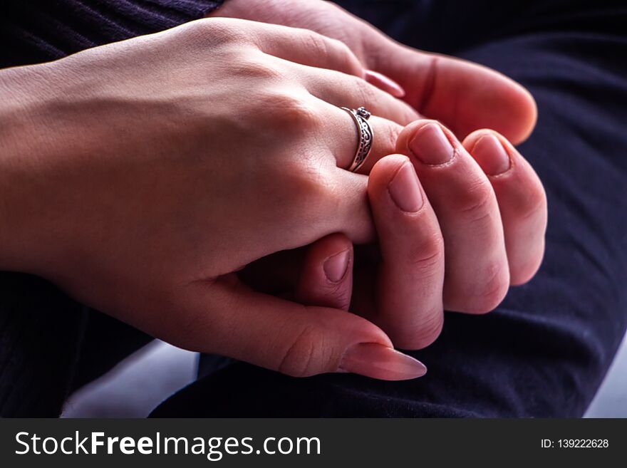 Girl`s hand, with a ring on his finger, in the hand of a guy close-up. Girl`s hand, with a ring on his finger, in the hand of a guy close-up