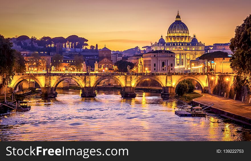 The dome of Saint Peters Basilica and Vatican City at sunset. Sant`Angelo Bridge over the Tiber River. Rome, Italy. The dome of Saint Peters Basilica and Vatican City at sunset. Sant`Angelo Bridge over the Tiber River. Rome, Italy
