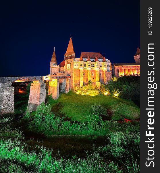 Beautiful night panorama of the Hunyad Castle / Corvin`s Castle with wooden bridge. Fantastic night scene of castle in Hunedoara, Transylvania, Romania, Europe