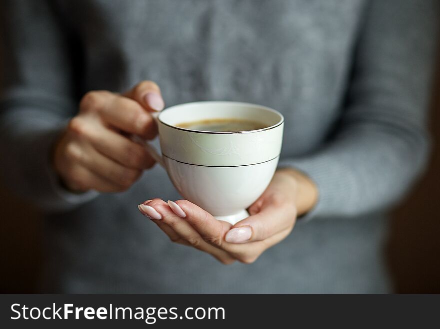 A cup of delicious cocoa in female hands. Concept drinks, lifestyle, work, background