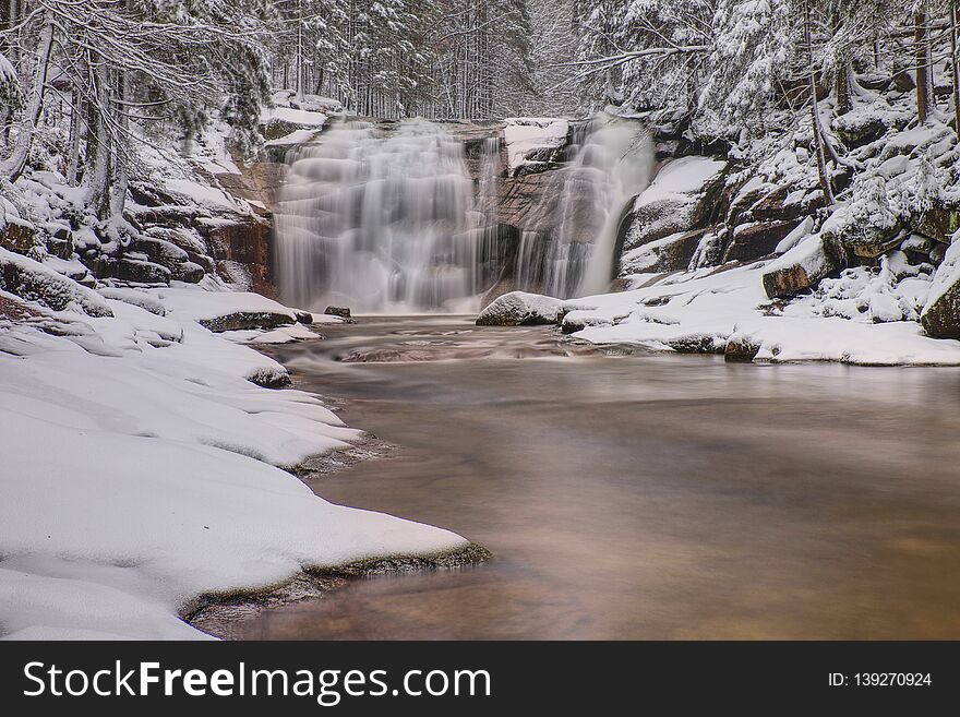 Frozen Waterfall In The Forest. Valley Of Mumlava River