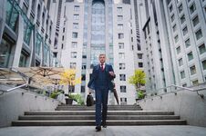 Serious Businessman In A Checkered Stylish Suit Coming Down The Stairs. Business Life In The City Stock Images Serious Businessman In A Checkered Stylish Suit Coming Down The Stairs. Business Life In The City Stock Images