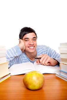 Young Smiling Male Student Learning Between Books Royalty Free Stock Photography Young Smiling Male Student Learning Between Books Royalty Free Stock Photography