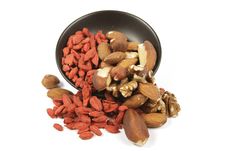 Goji Berries And Nuts Spilling From A Bowl Stock Photography Goji Berries And Nuts Spilling From A Bowl Stock Photography
