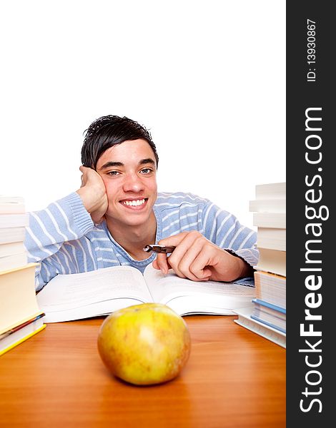 Young Smiling Male Student Learning Between Books