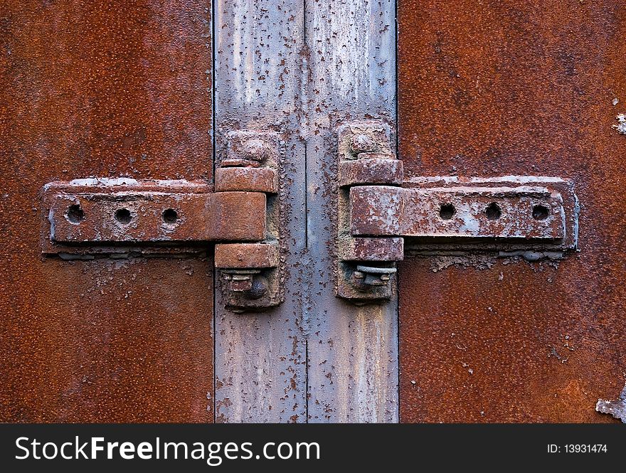 Old rusty metal hinge in the centre
