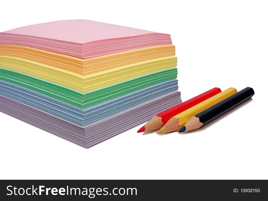 Colored paper for notes and three pencils. Colored paper for notes and three pencils