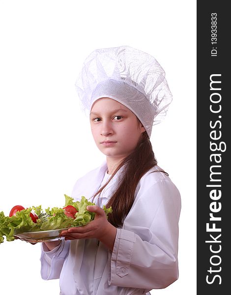 Portrait of teenager girl in chef uniform with vegetarian food. Isolated on white by lighting setup. Portrait of teenager girl in chef uniform with vegetarian food. Isolated on white by lighting setup