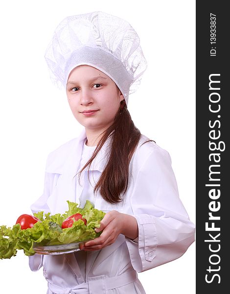 Portrait of teenager girl in chef uniform with vegetarian food. Isolated on white by lighting setup. Portrait of teenager girl in chef uniform with vegetarian food. Isolated on white by lighting setup