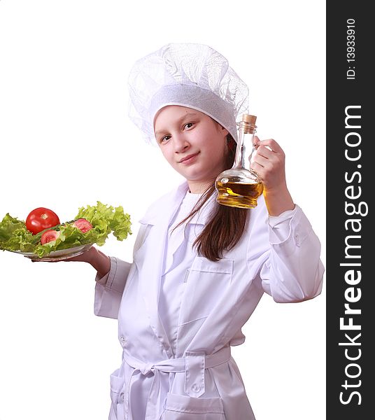 Portrait of teenager girl in chef uniform with vegetarian food. Isolated on white by lighting setup. Portrait of teenager girl in chef uniform with vegetarian food. Isolated on white by lighting setup