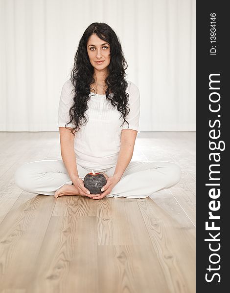 Young woman with long black curly hair doing yoga. Young woman with long black curly hair doing yoga