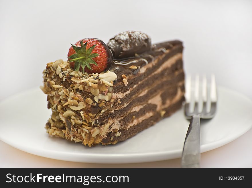 Chocolate cake on the white plate with fork. Chocolate cake on the white plate with fork