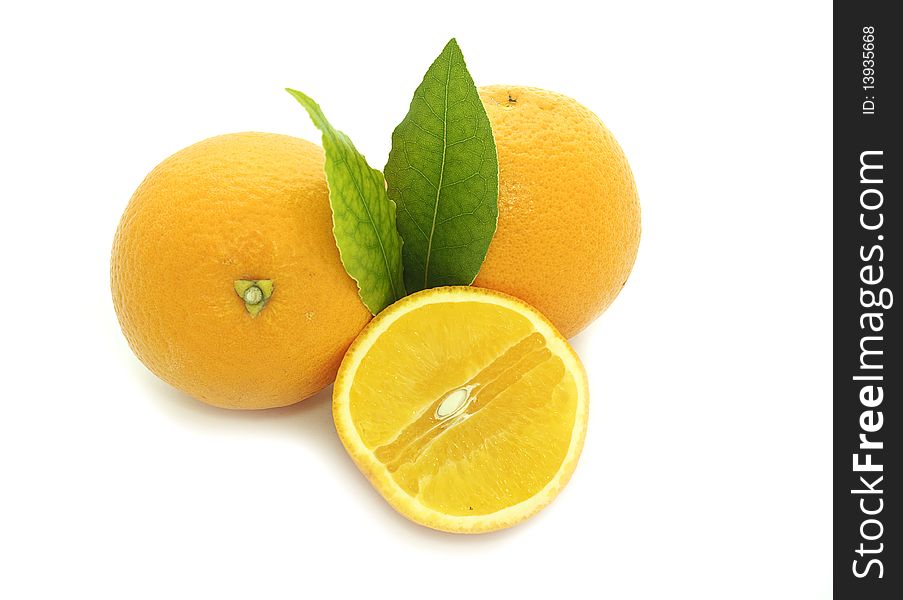 Fresh oranges with green leaves isolated on a white background. Fresh oranges with green leaves isolated on a white background