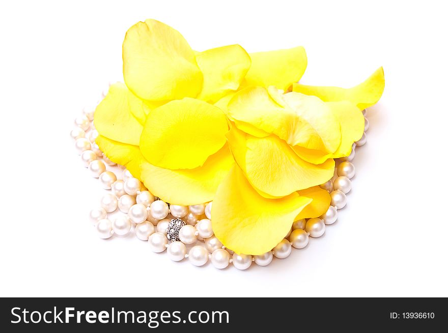 Yellow roses petals and white pearls isolated on white background. Yellow roses petals and white pearls isolated on white background