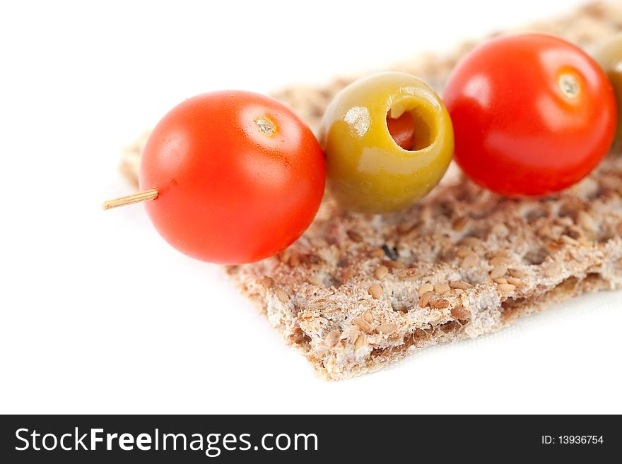 Close up of artistic food of tomatoes, olives and biscuit