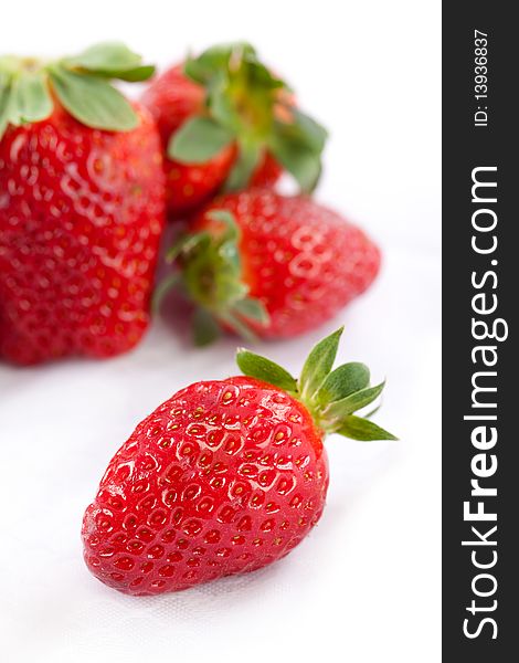 Close up of fresh and clean strawberries pn bright white background. Close up of fresh and clean strawberries pn bright white background