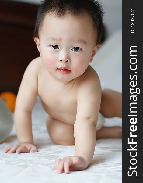 This is a photo of a one year old boy who was being attracted by the lens on the camera. This is a photo of a one year old boy who was being attracted by the lens on the camera.