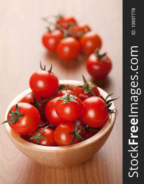 Ripe cherry tomatoes in wooden bowl. Ripe cherry tomatoes in wooden bowl