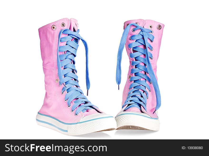 Two pink lace boots on a white background