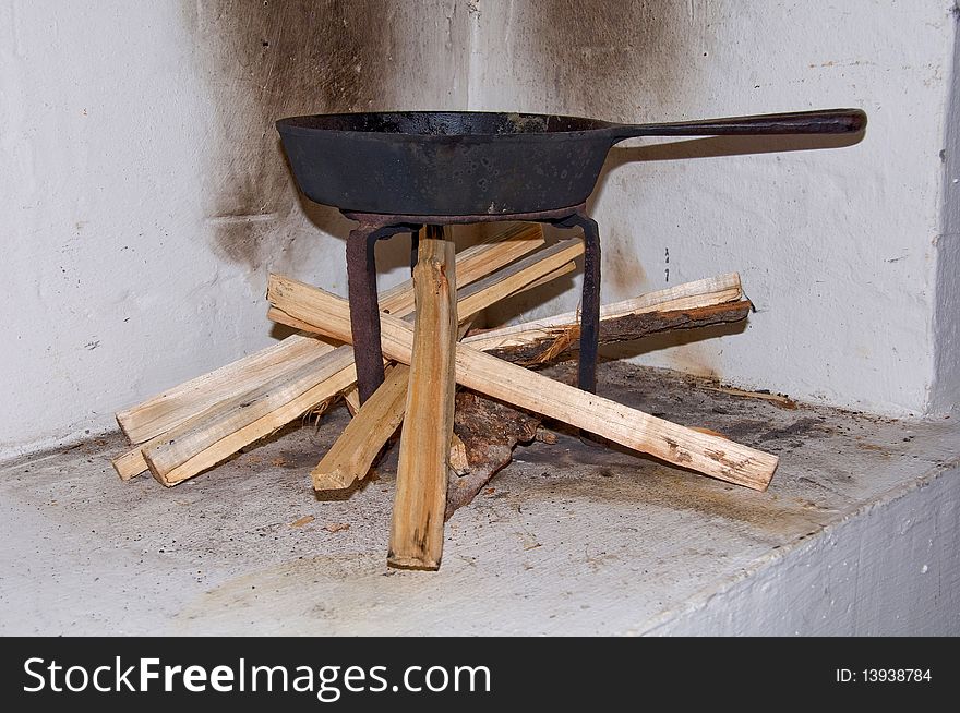 Old frying pan above a wood