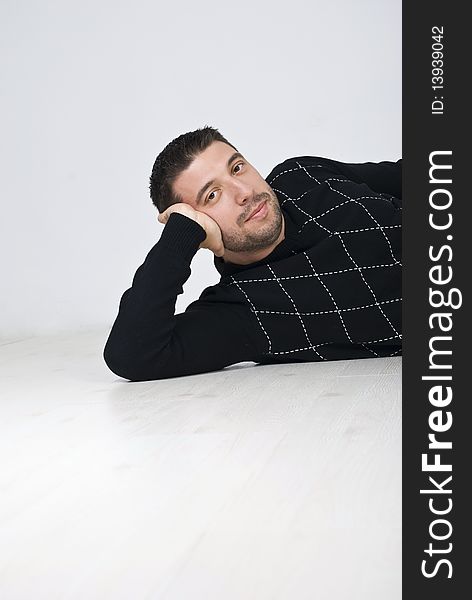 Attractive Man Sitting On Wooden Floor