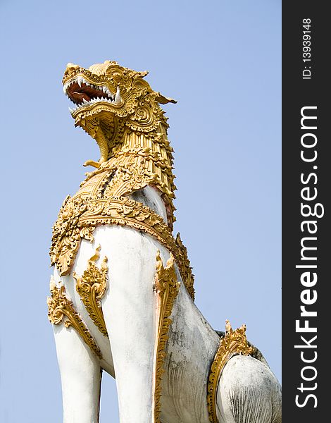 A statue of Singha guarding the door of a temple in Chiang Rai, Thailand. A statue of Singha guarding the door of a temple in Chiang Rai, Thailand