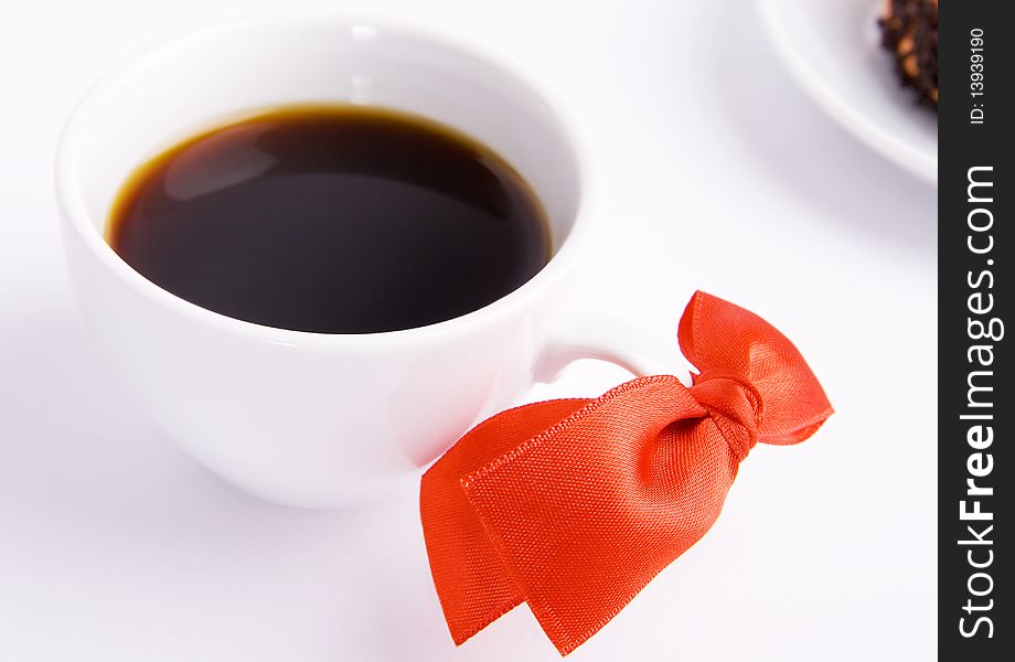 Coffee cup with a red bow on white