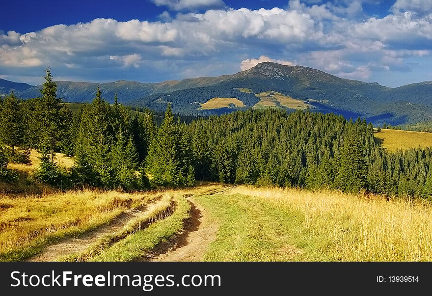 Summer landscape in mountains and the dark blue sky with clouds. Summer landscape in mountains and the dark blue sky with clouds